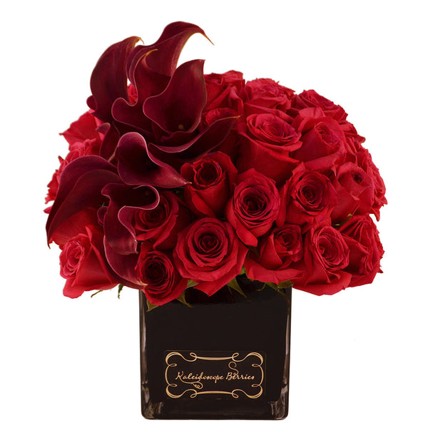 Dozens of red roses and burgundy cala lilies in square cube black vase
